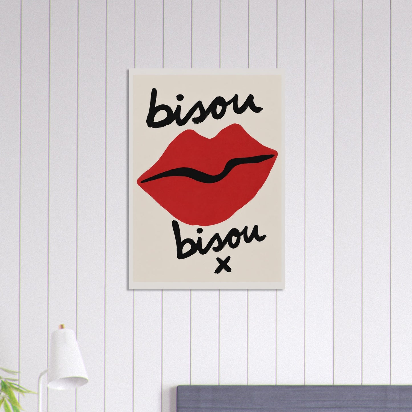 Canvas print with red lips and 'bisou bisou x' text on a white wall.