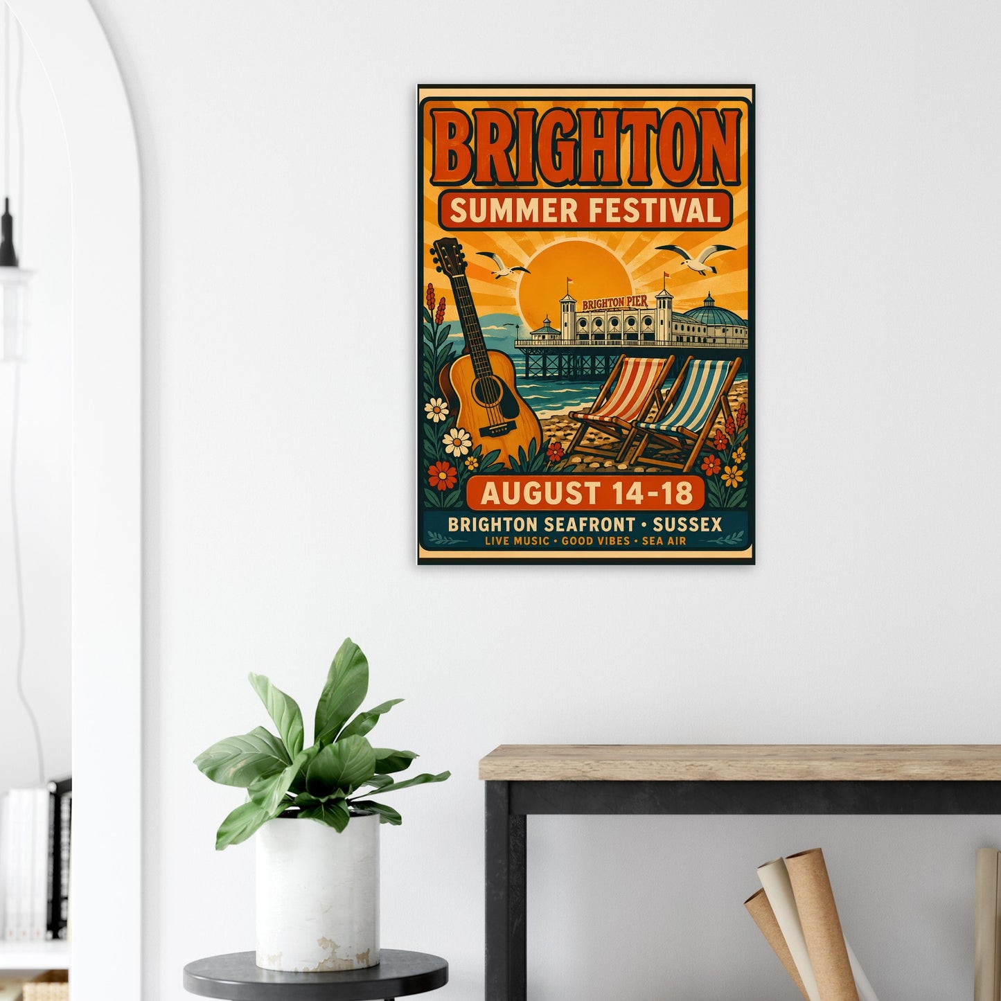 Brighton Summer Festival poster on a wall above a desk with a plant