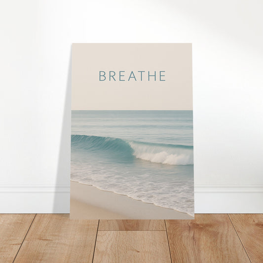 Minimalist ocean wave poster with the word BREATHE, styled on a wooden floor for home wall art display