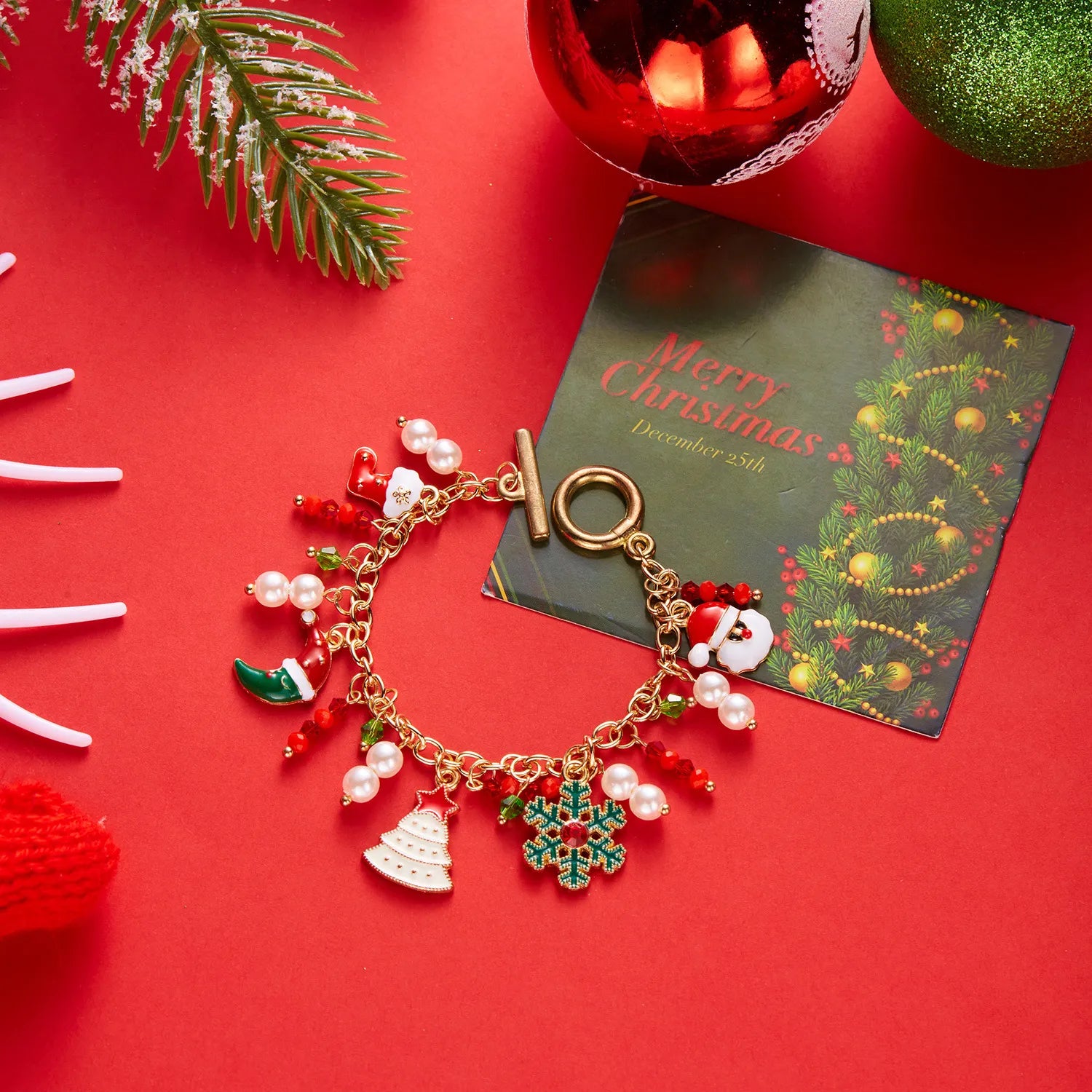 Christmas-themed bracelet with charms on a red background