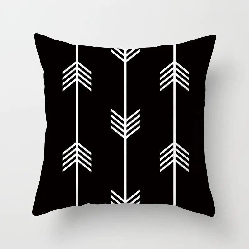 Black pillow with white arrow pattern on a light gray background