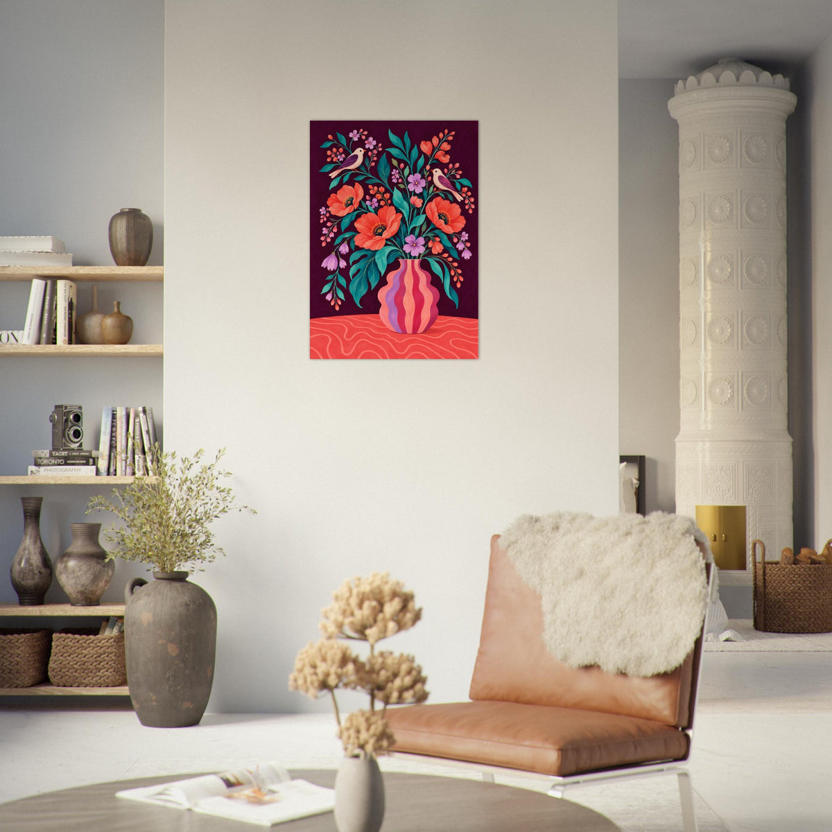 A colorful square wall art print depicting a floral bouquet in a pink vase, displayed on a white wall in a modern living room setting with a brown leather chair, a large gray vase, and a white decorative column.