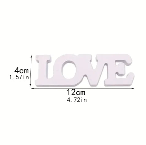 White wooden letters spelling 'LOVE' with measurements on a white background