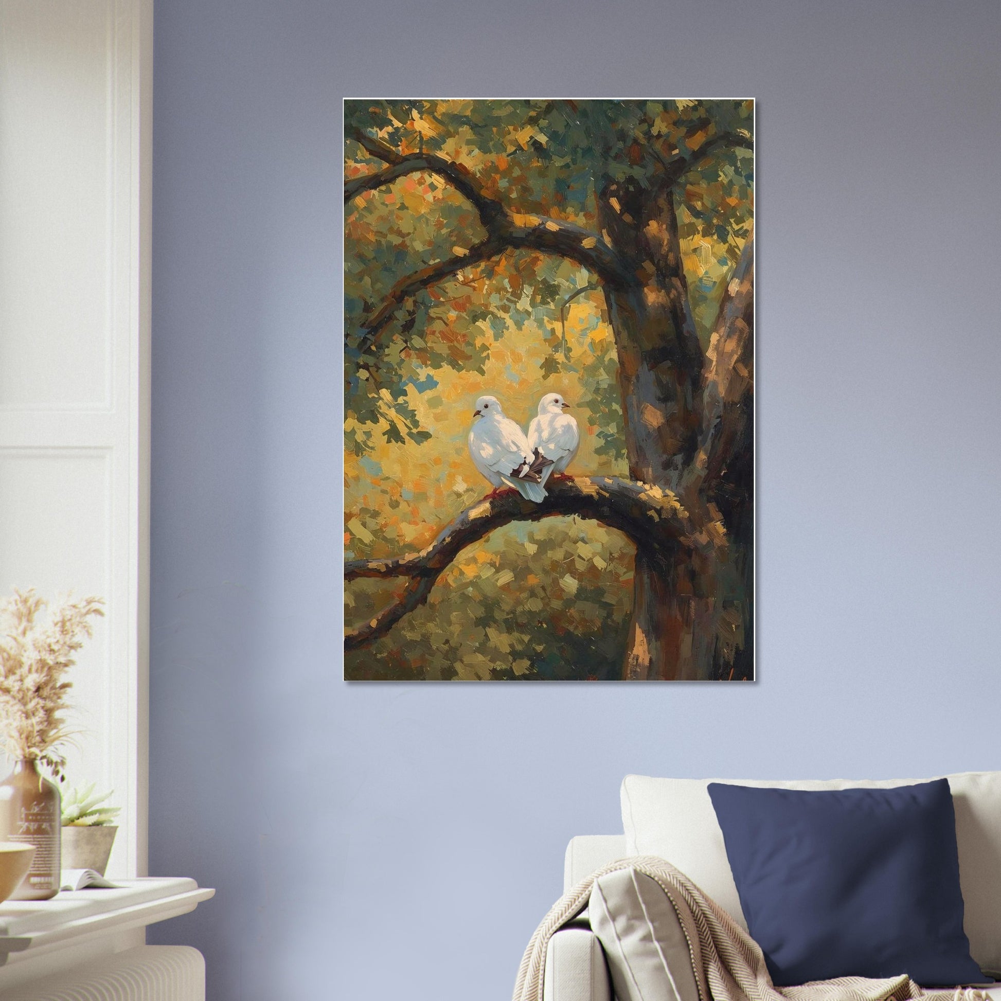 Painting of two white birds on a branch in a forest setting, hanging on a wall above a sofa.