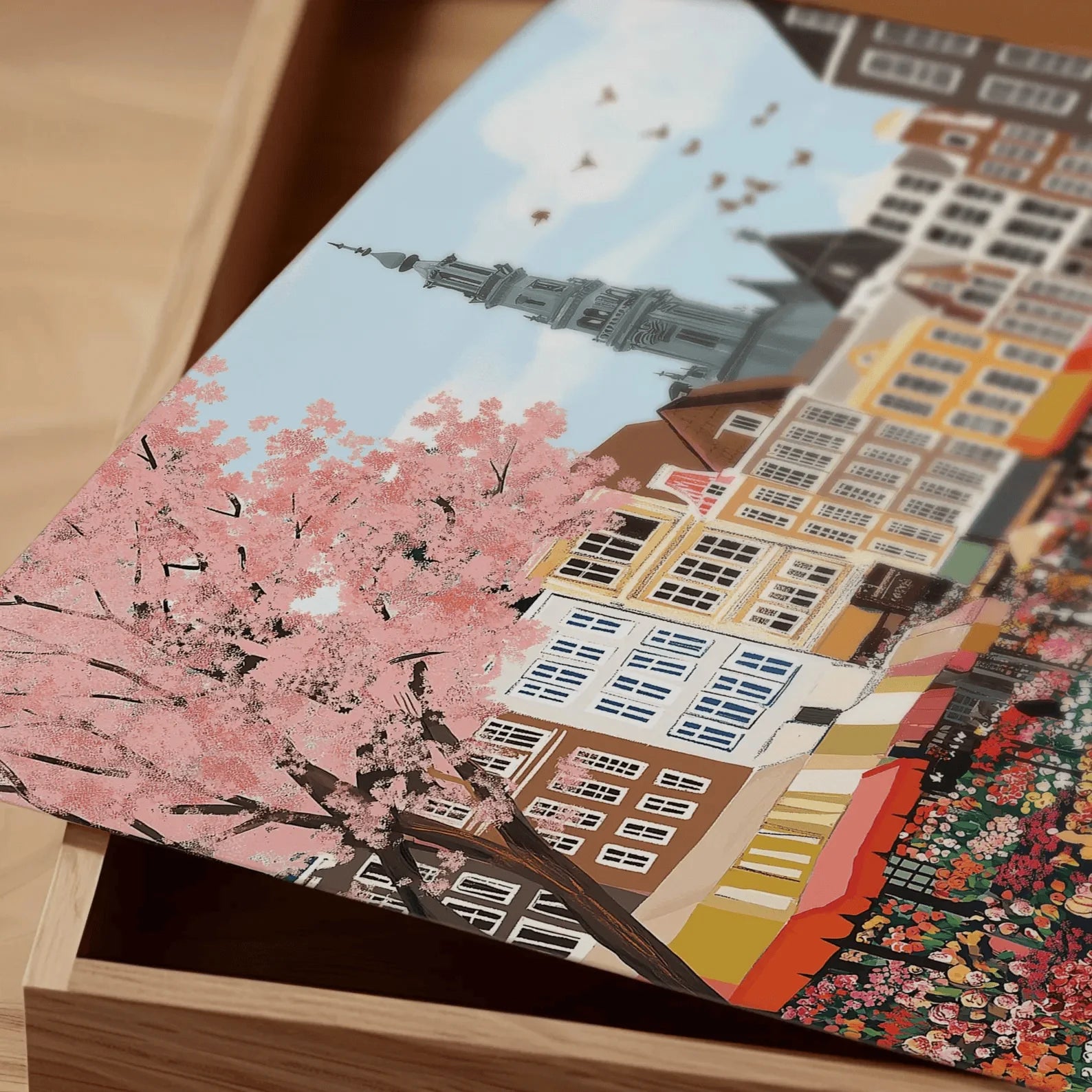 Card with cherry blossom and cityscape design on a wooden surface
