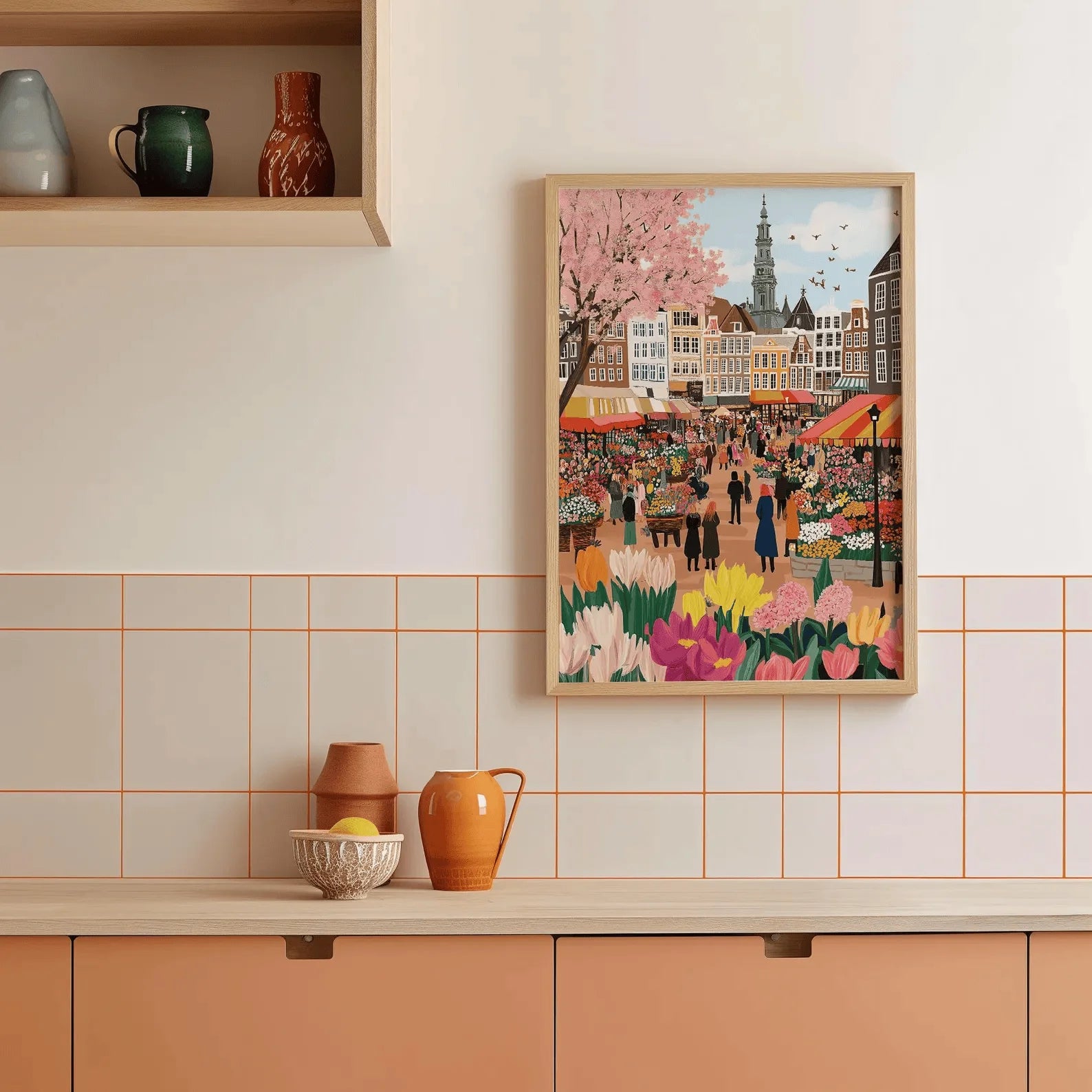 Framed artwork of a market scene with cherry blossoms on a kitchen wall.