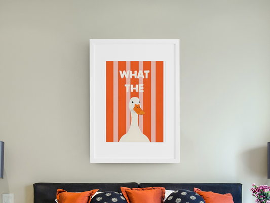 Framed artwork with a duck illustration and text on a wall above a bed.