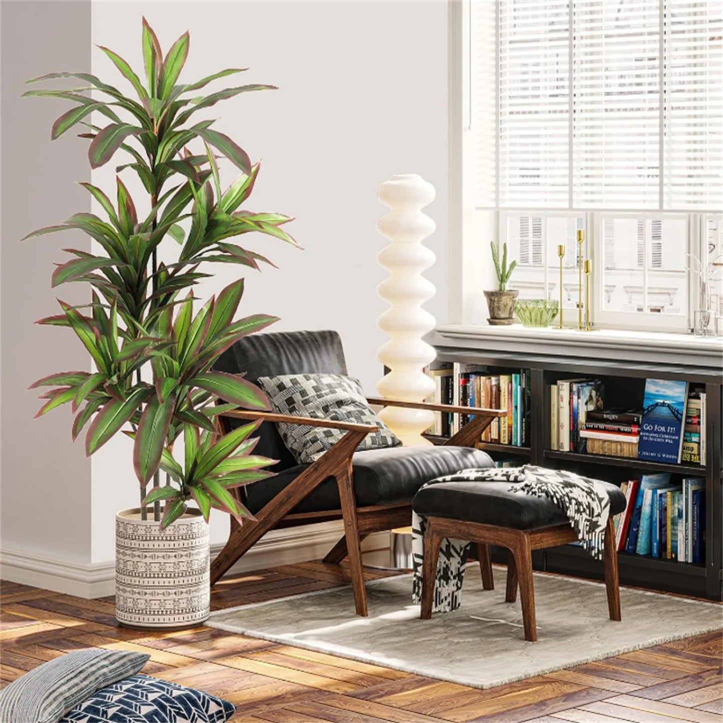 Living room with an artificial plant, sofa, and bookshelf.