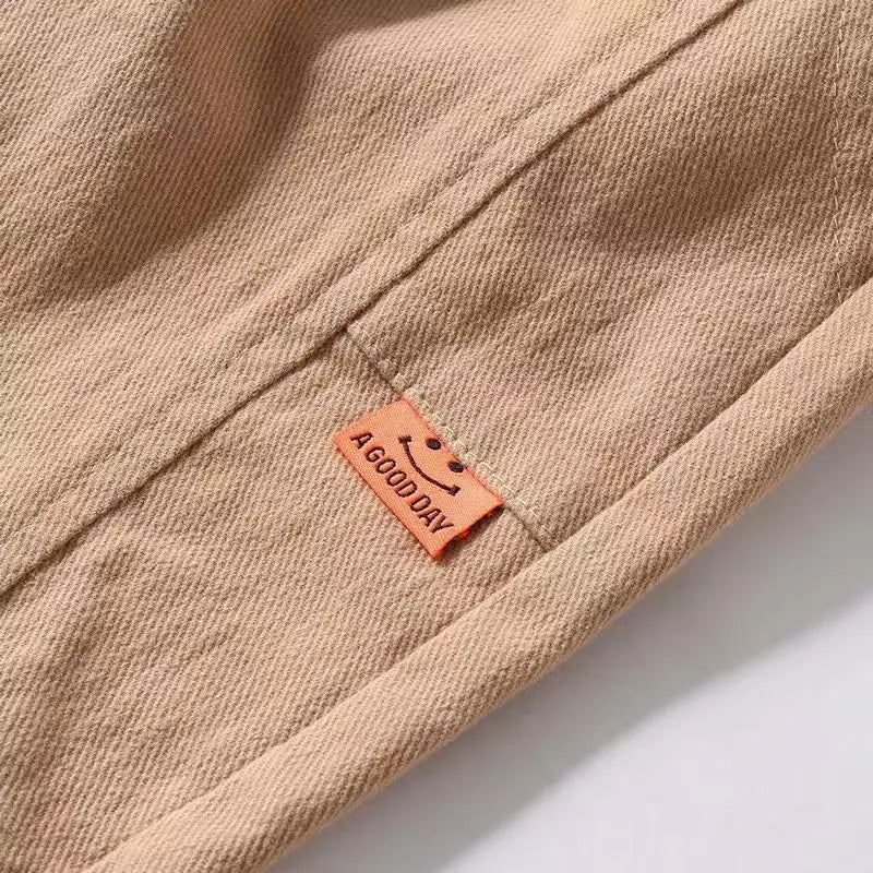 Close-up of a brown fabric with a 'A Good Day' label on a white background