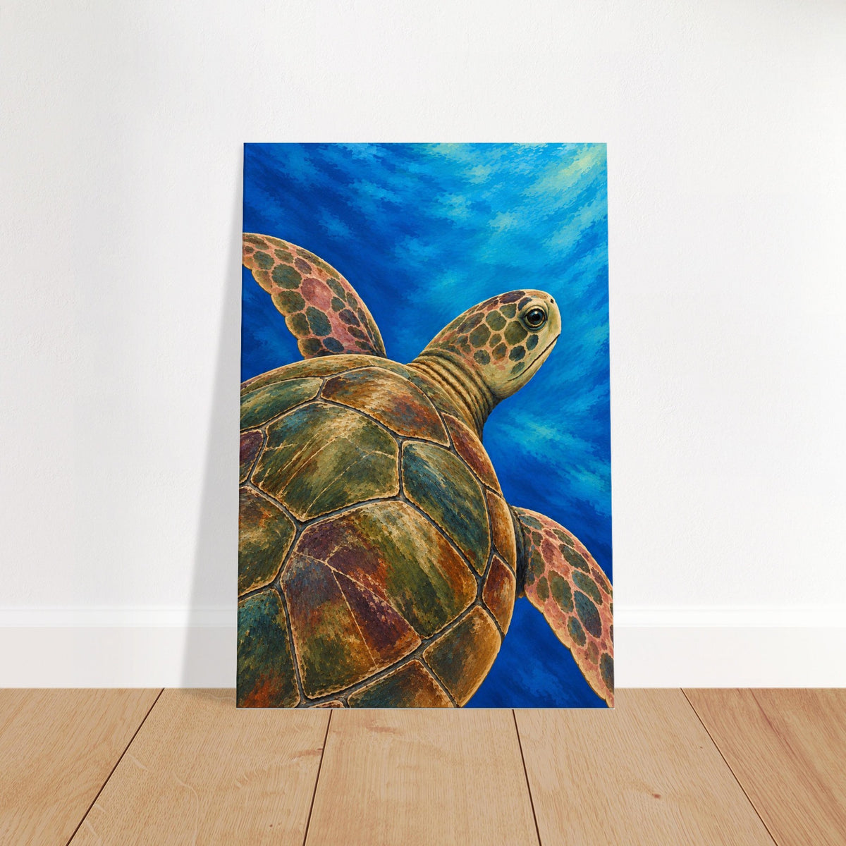 A vertical canvas art print depicting a painted sea turtle swimming underwater in shades of blue, green, and brown, leaning against a white wall on a light wood floor.