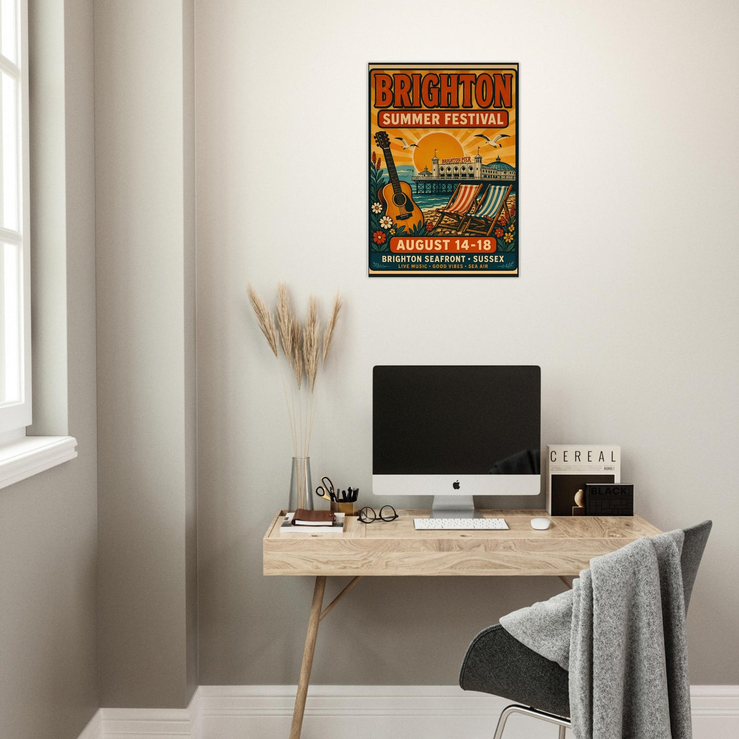 Modern office setup with a desk, computer, and Brighton Summer Festival poster on the wall.
