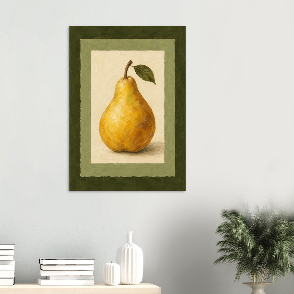 A framed still life art print of a yellow pear with a green leaf, displayed on a light gray wall above a shelf with books and decorative vases, with a potted plant on the right.