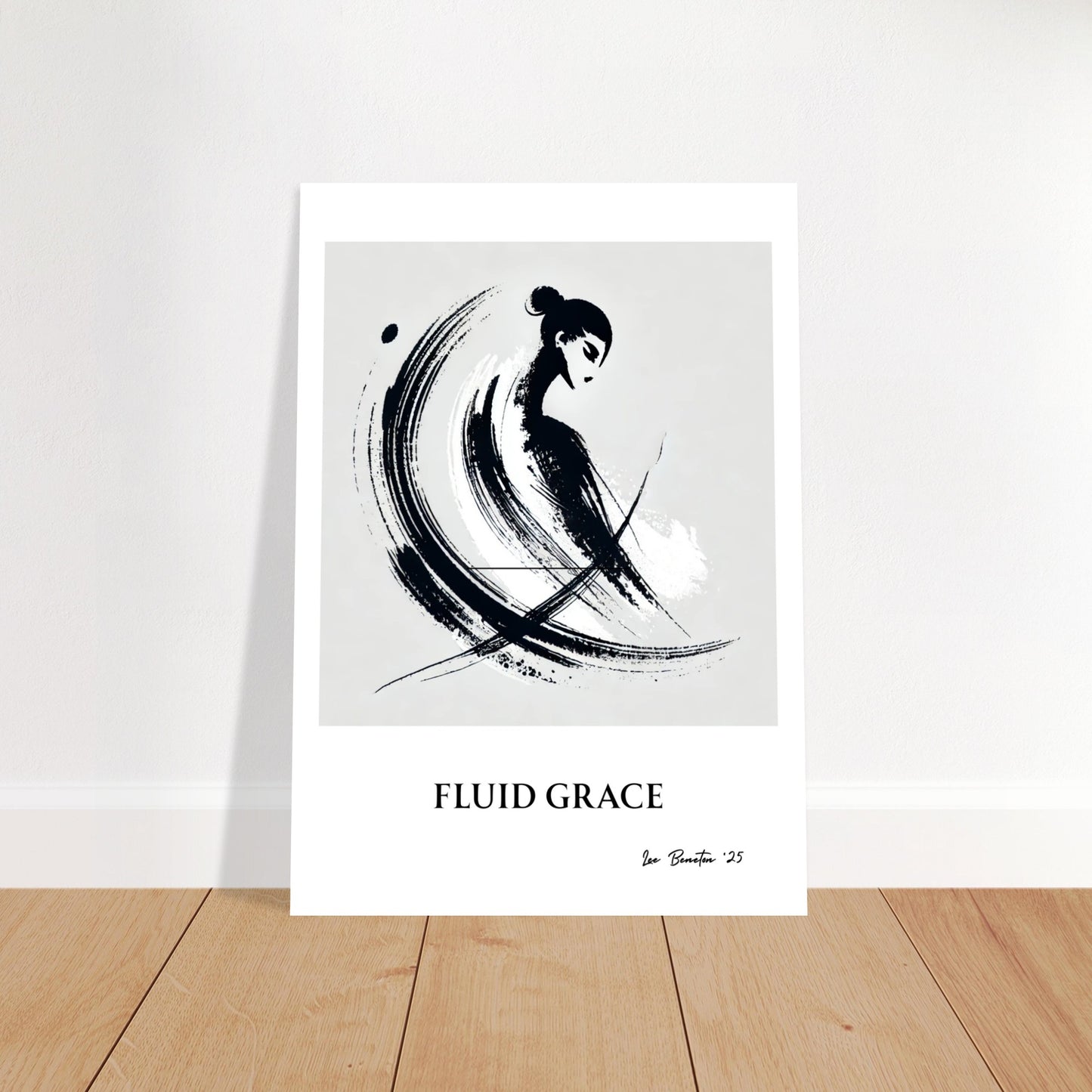 Minimalist ink brush stroke art poster leaning against wall on wooden floor, abstract black brush design on white background.