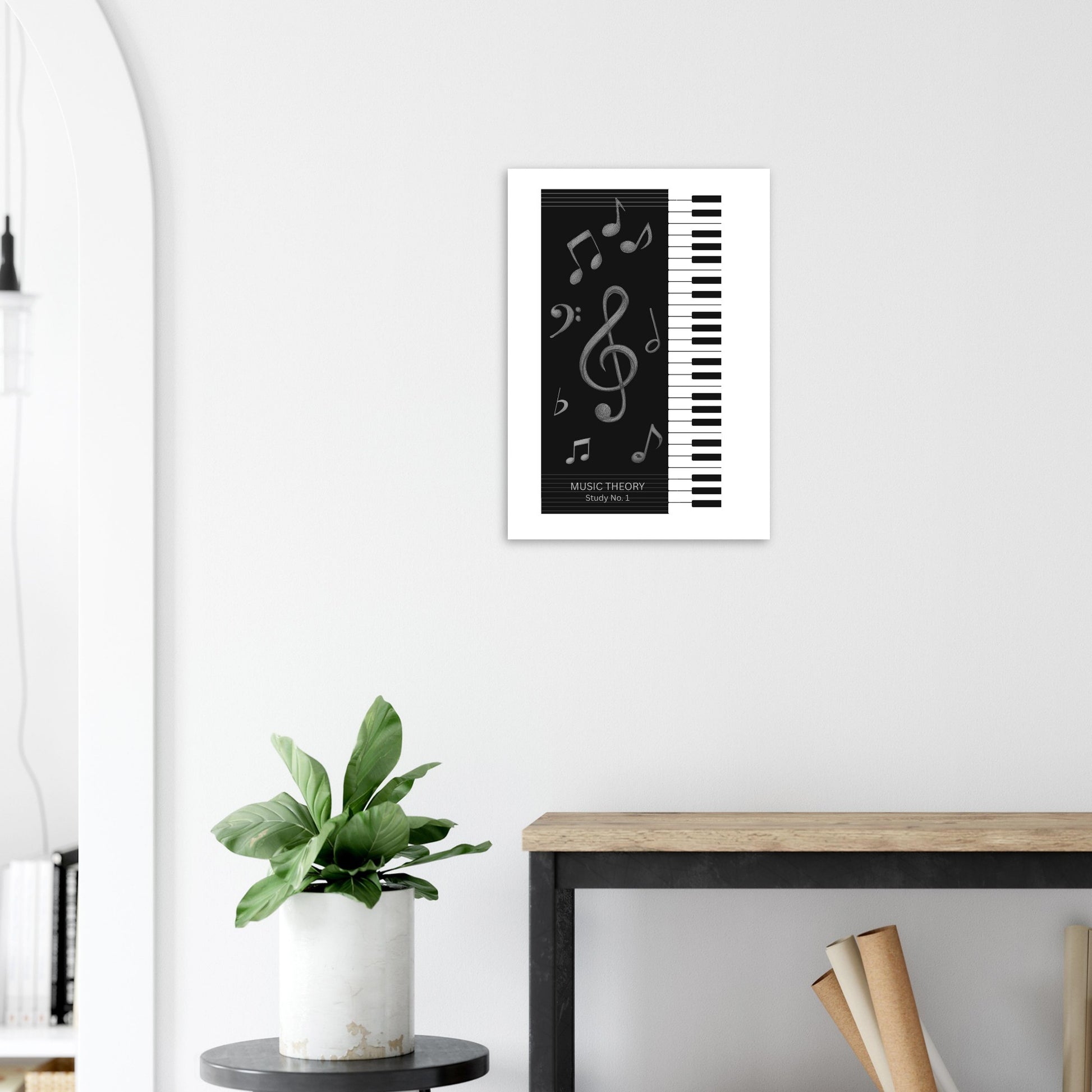 Framed music-themed artwork on a wall above a desk with a plant.