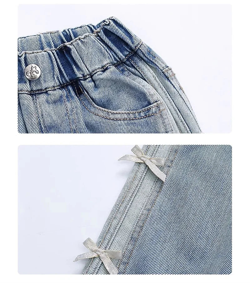Close-up of light blue denim jeans with a button and lace detail on a white background.