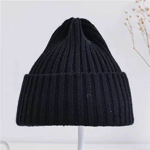 Black knit beanie on a white background