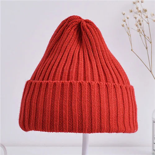 Red knitted beanie on a white background
