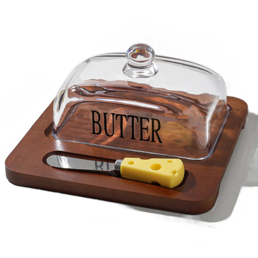 Wooden butter dish with glass cover and yellow knife on a white background
