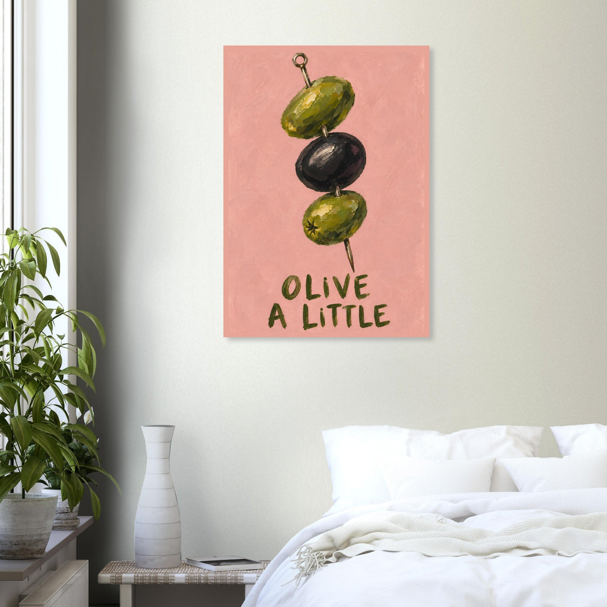Olive a Little print on a pale bedroom wall above a desk, beside shelves, a bed and a tall window.