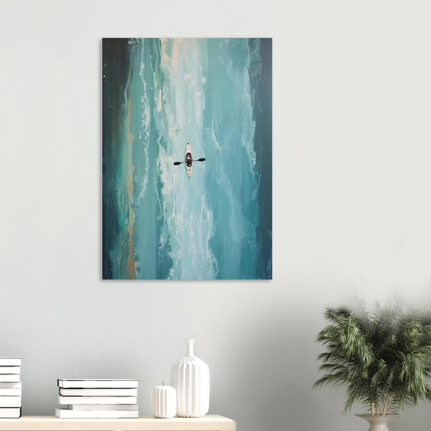 Canvas print of a kayaker in water on a white wall above a shelf with decor items.