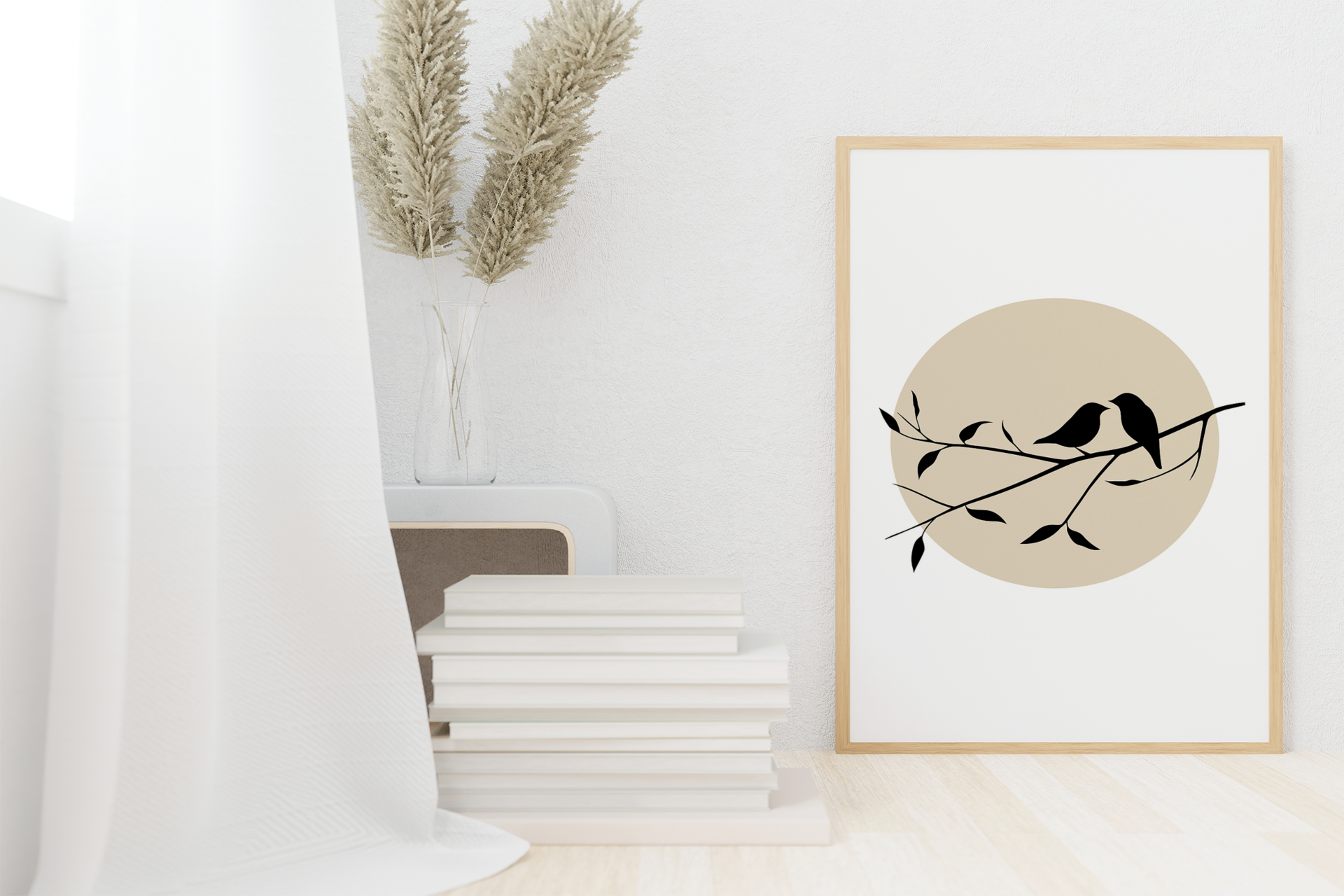 Bird silhouette poster with beige sun, leaning against wall beside stacked books and dried pampas grass in a minimalist white room.

