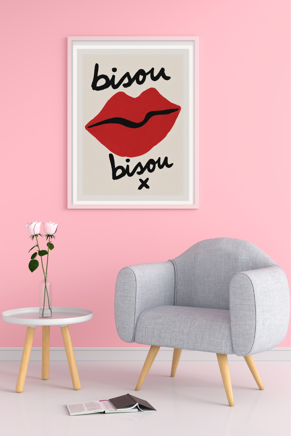 Framed artwork with red lips and 'bisou' text on a pink wall above a gray chair.