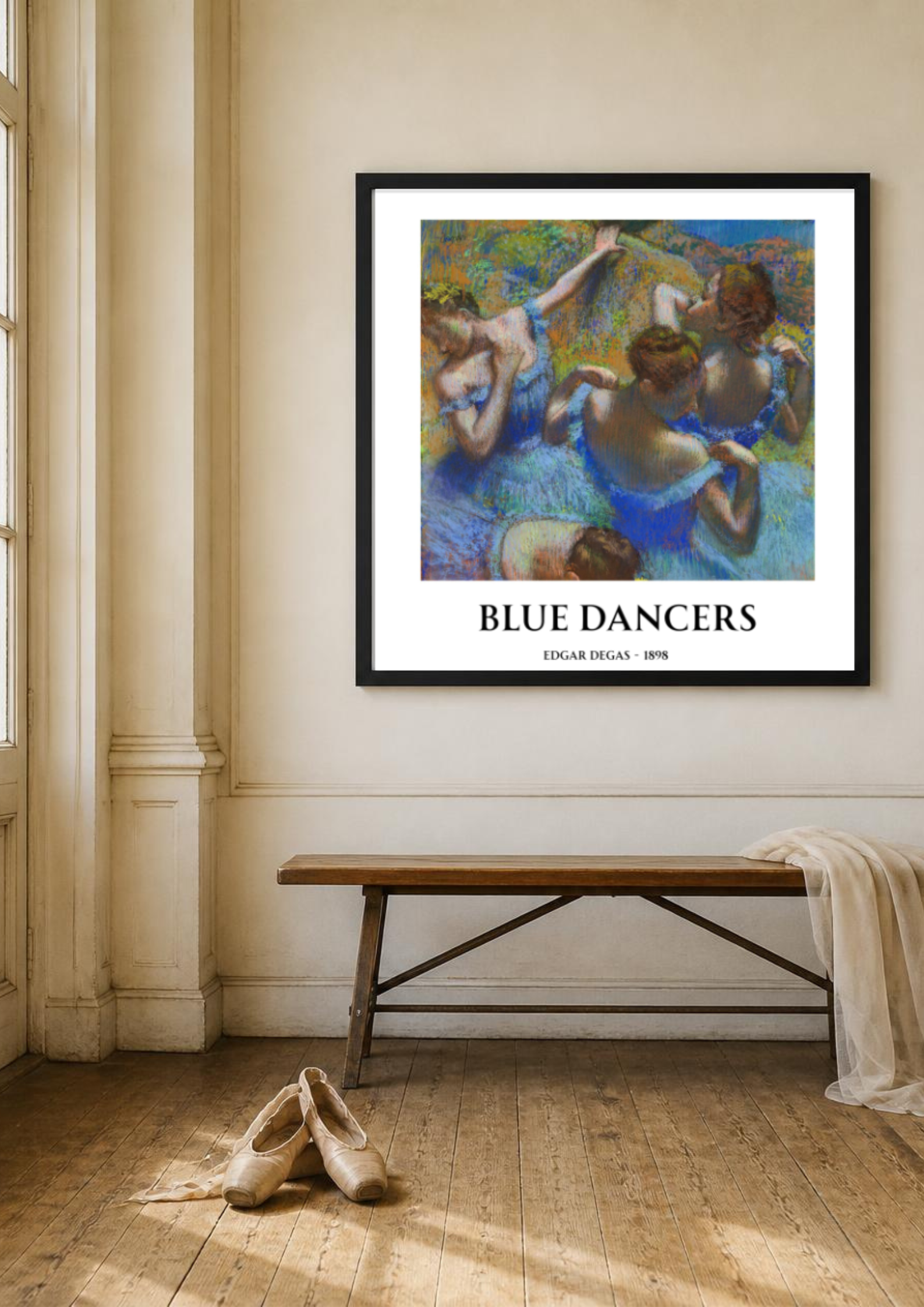 Framed Blue Dancers by Edgar Degas displayed in a bright ballet studio with wooden flooring, ballet shoes and a minimalist bench.