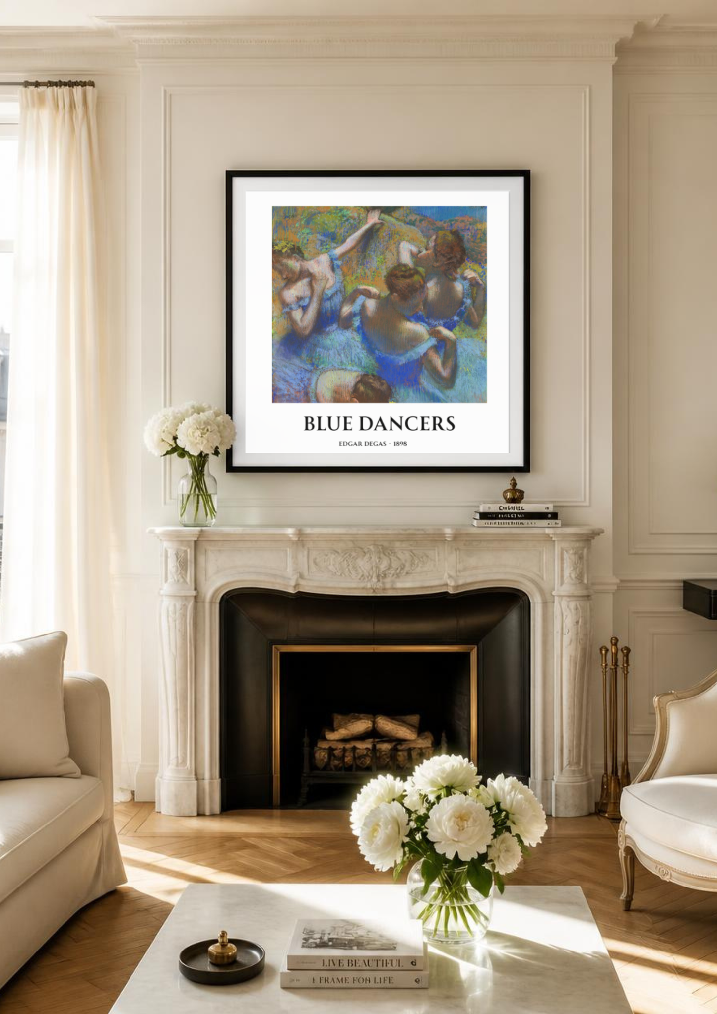 A framed art print titled 'BLUE DANCERS' hangs on a cream paneled wall above a classic white fireplace mantel in a beautifully styled living room.
