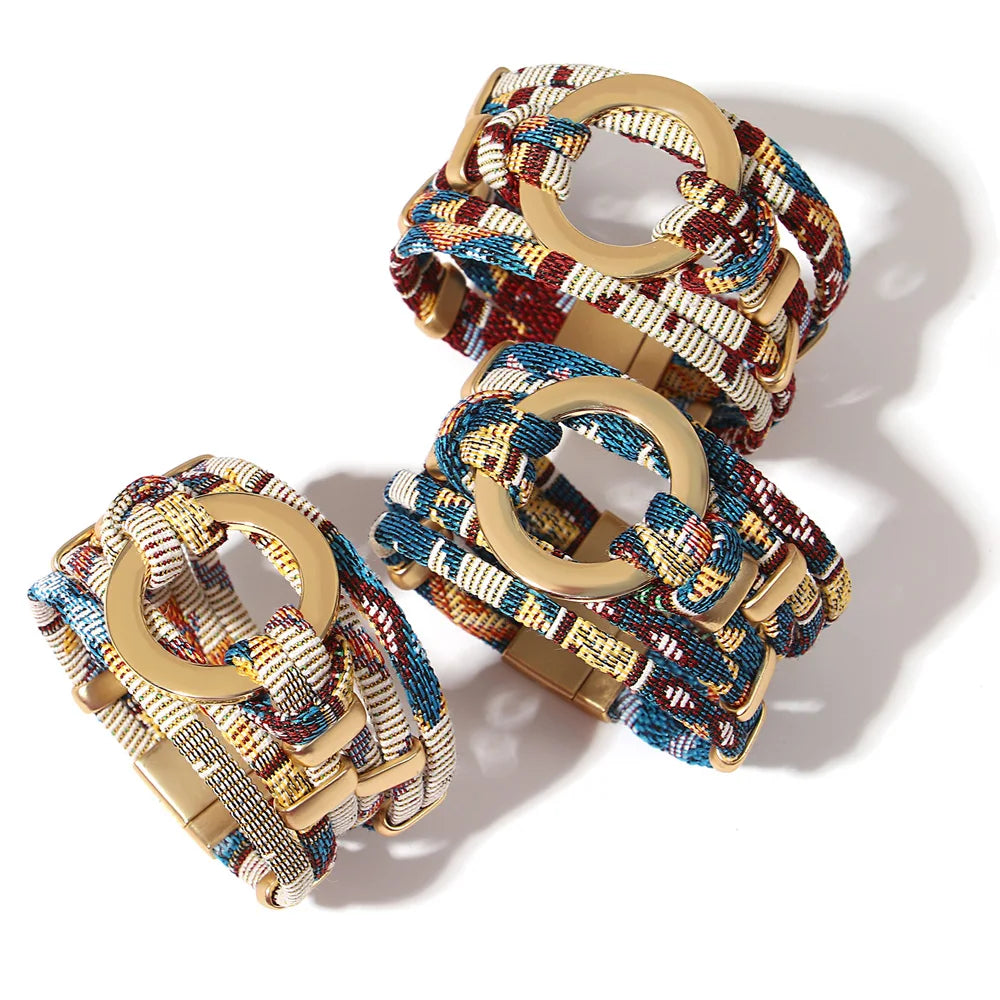 Two colorful woven bracelets with wooden rings on a white background