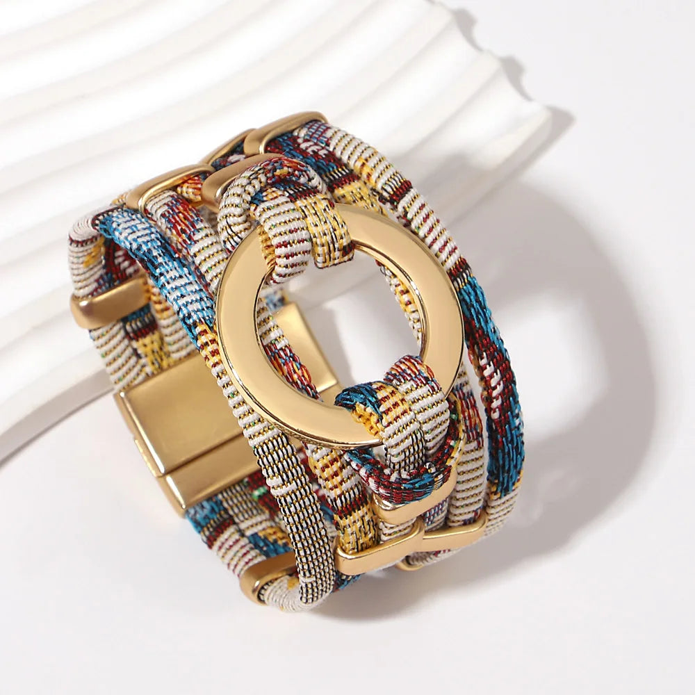 Multicolored woven bracelet with a gold clasp on a white background