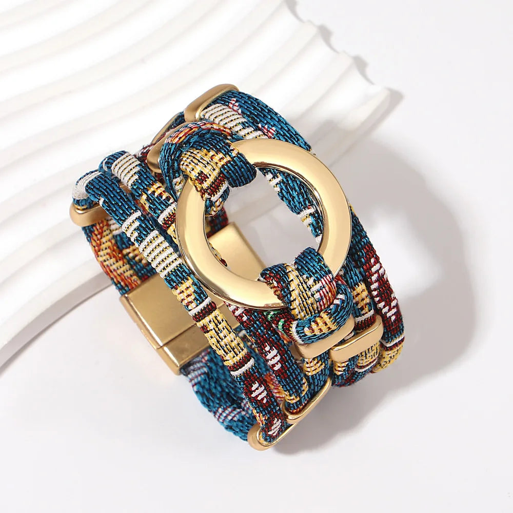 Bracelet with gold clasp and multicolored braided design on a white background
