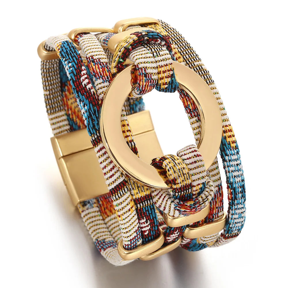 Multicolored braided bracelet with gold clasp on a white background