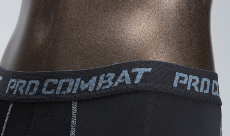 Black athletic wear with 'Pro Combat' branding on a gray background