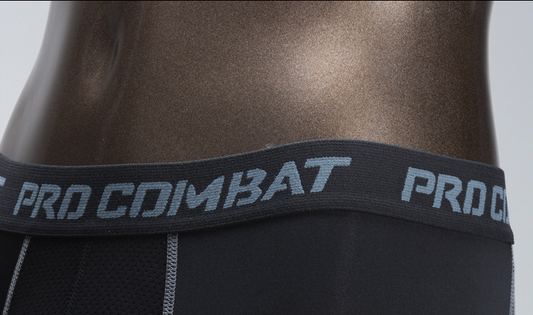 Black athletic wear with 'Pro Combat' branding on a gray background