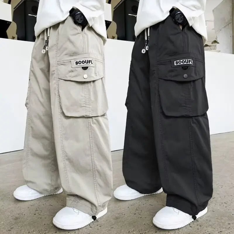 boys loose cargo pants in grey and black side by side.