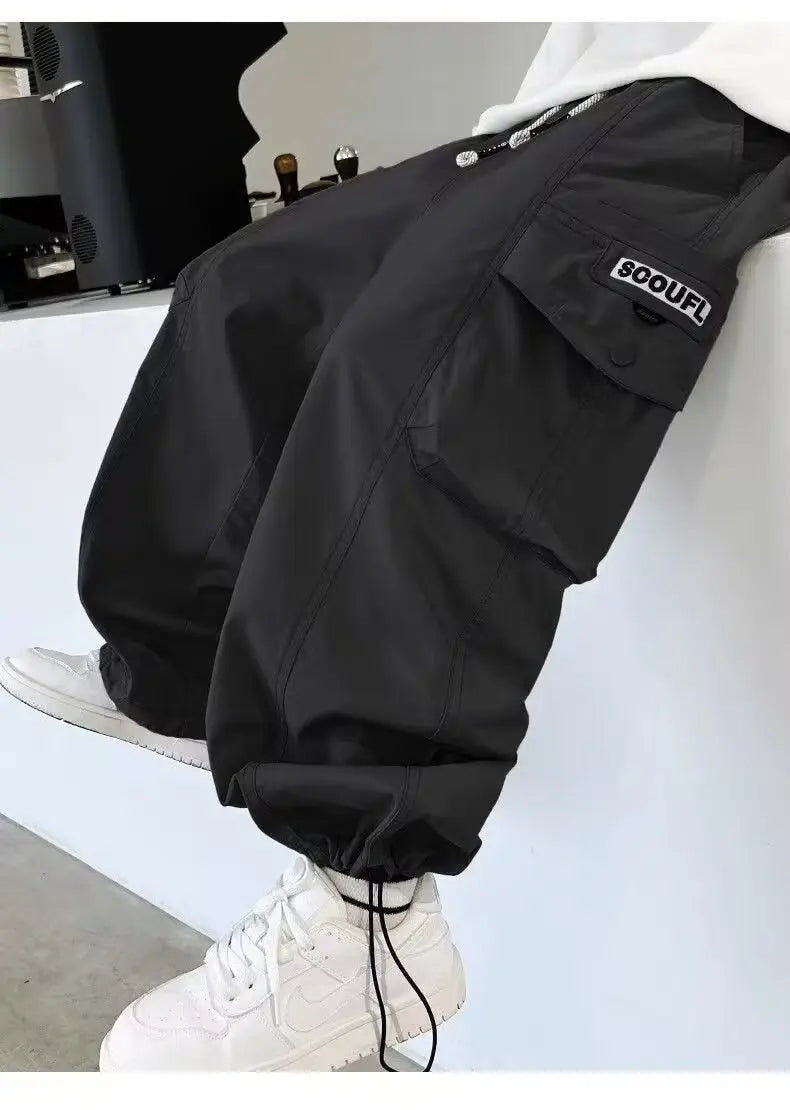 Close-up showing large side pocket with “SOOUFL” patch.