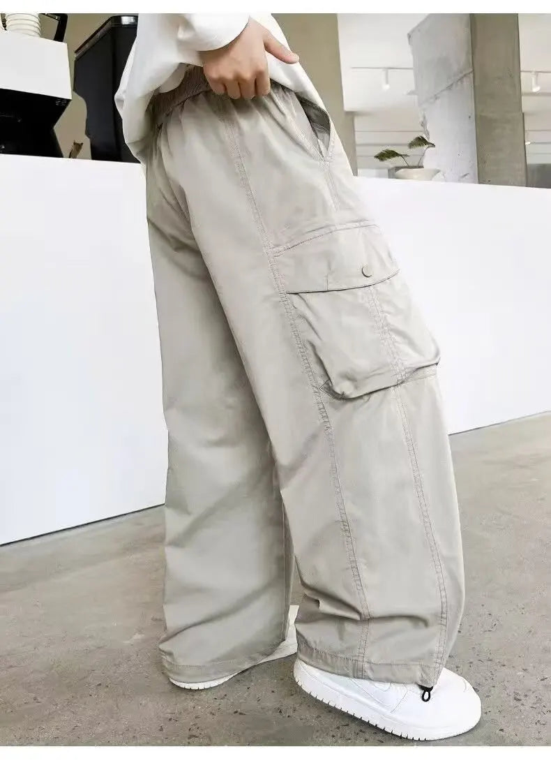 Person wearing beige cargo pants in an indoor setting