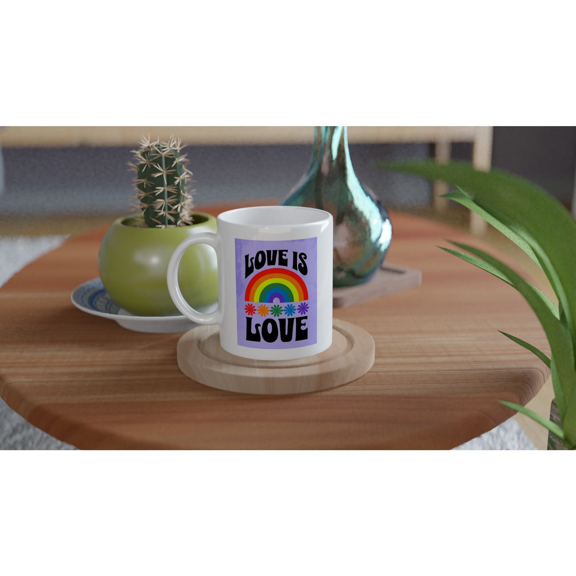 White mug with a rainbow and 'Love is Love' text on a wooden table