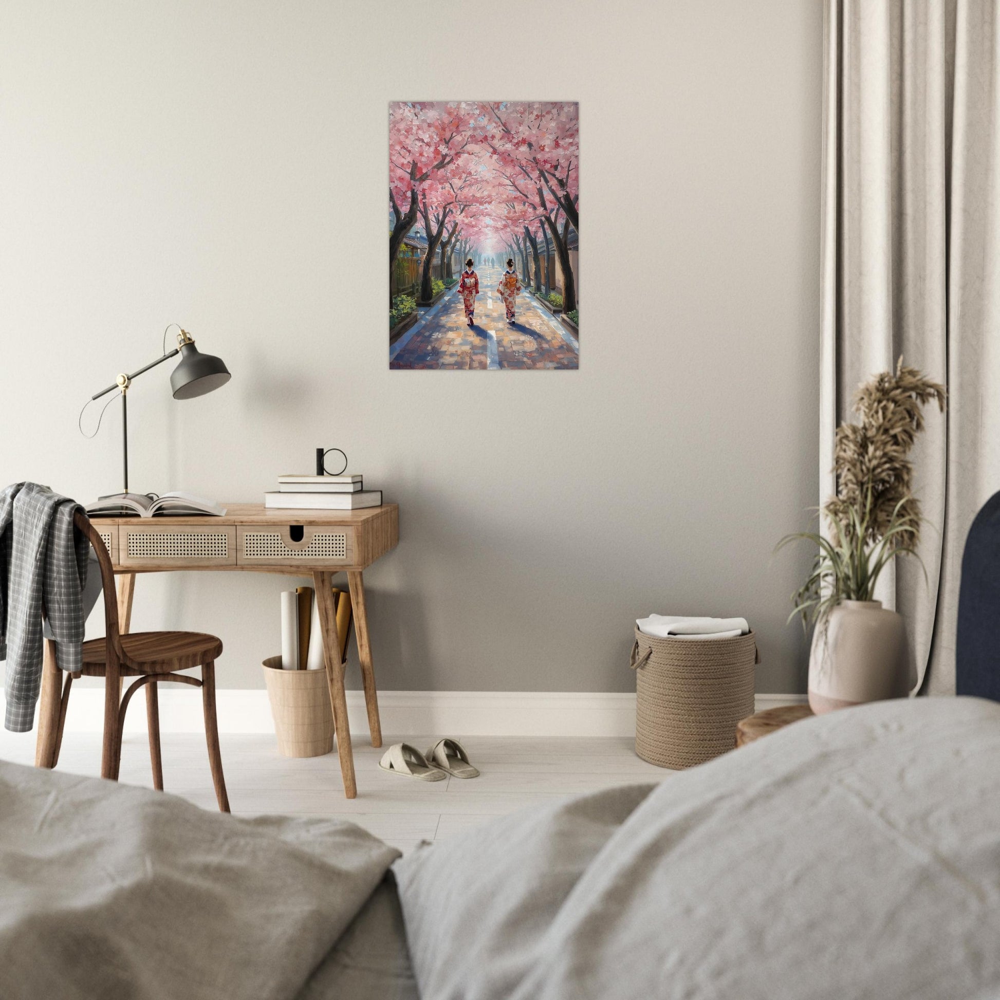 Room interior with a desk, lamp, and painting of cherry blossoms on the wall.