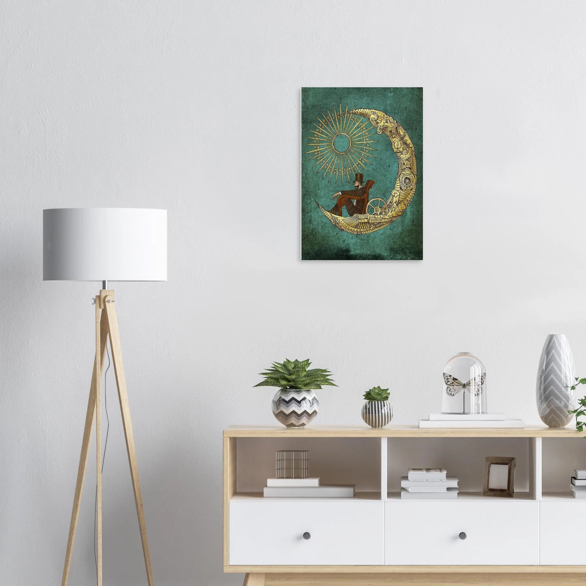 Decorative wall art of a man sitting on a crescent moon above a shelf with decor items.