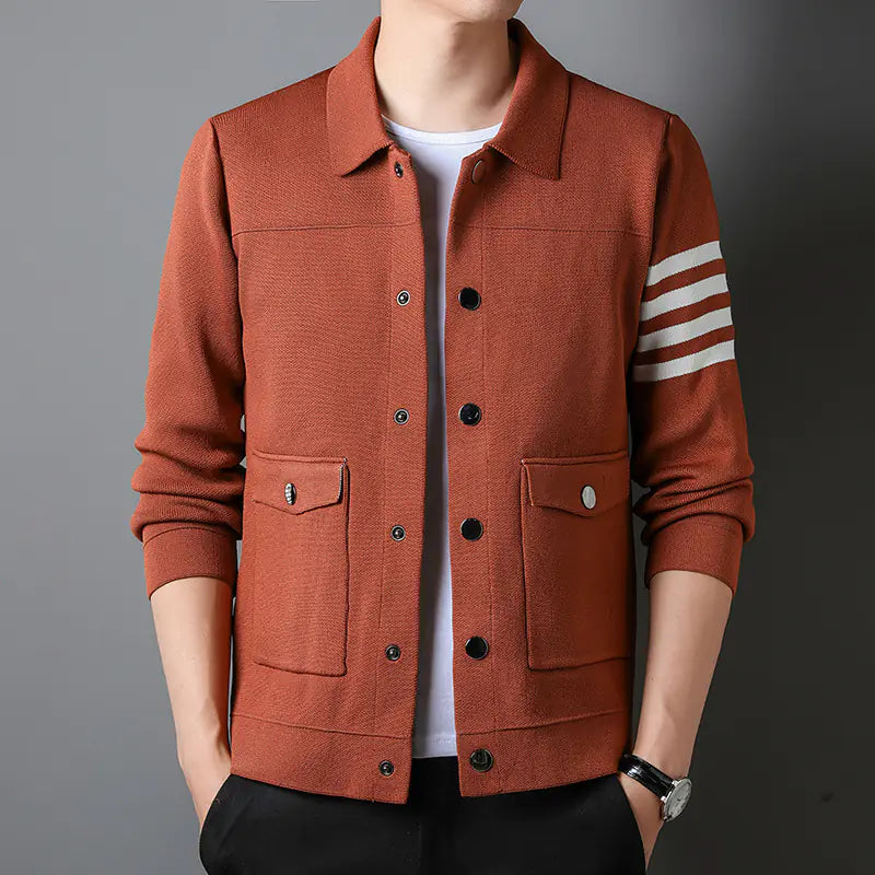Brown jacket with white stripes on sleeves against a gray background