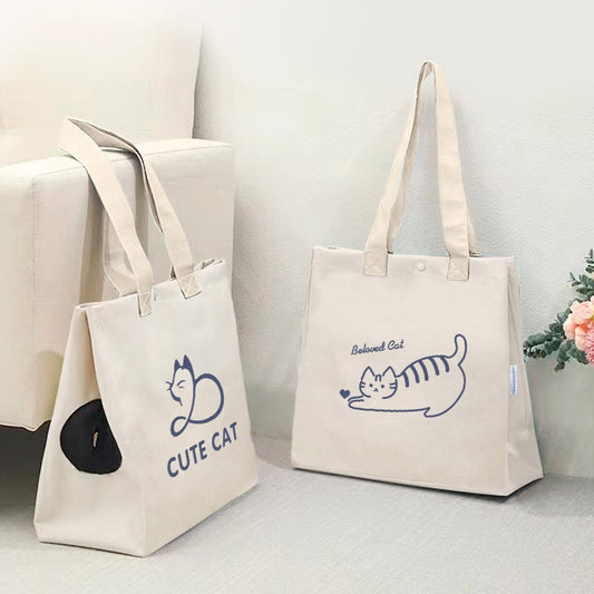 Two tote bags with cat illustrations and text on a light background