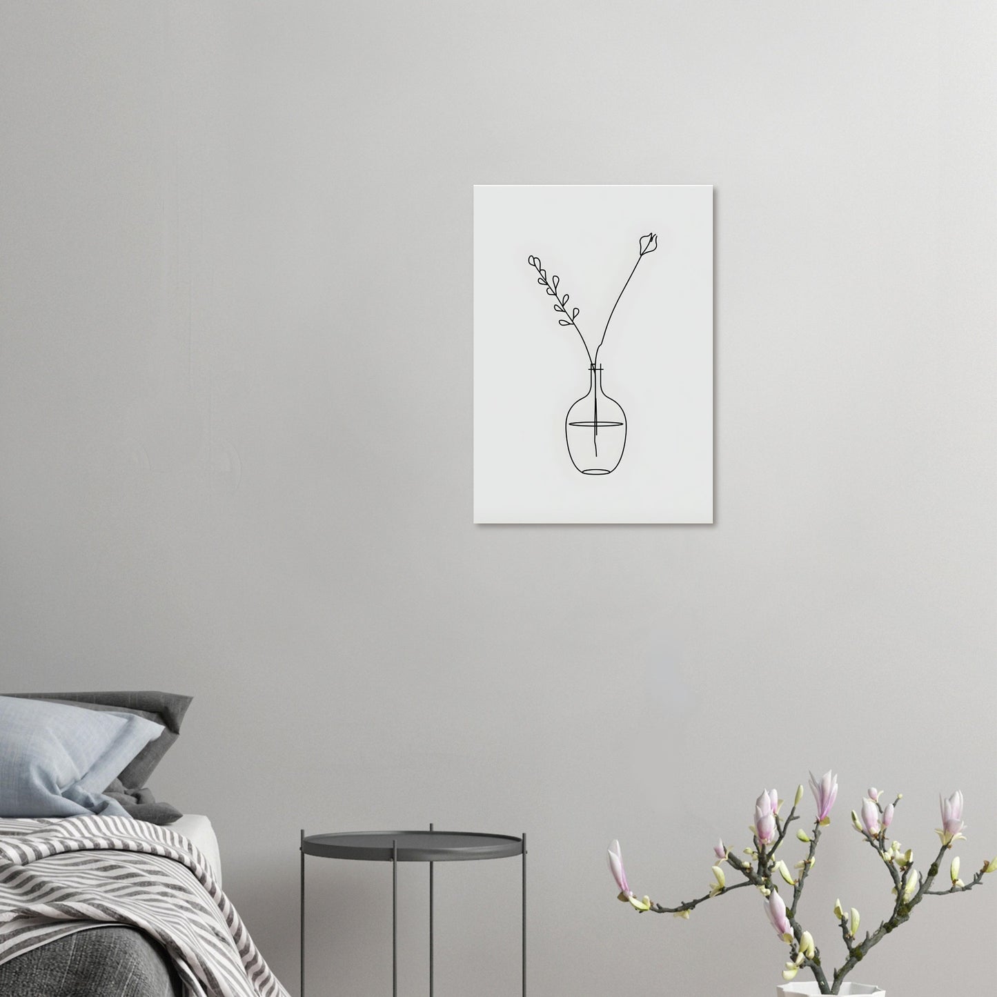 Minimalist line art of a vase with flowers on a gray wall above a bed.