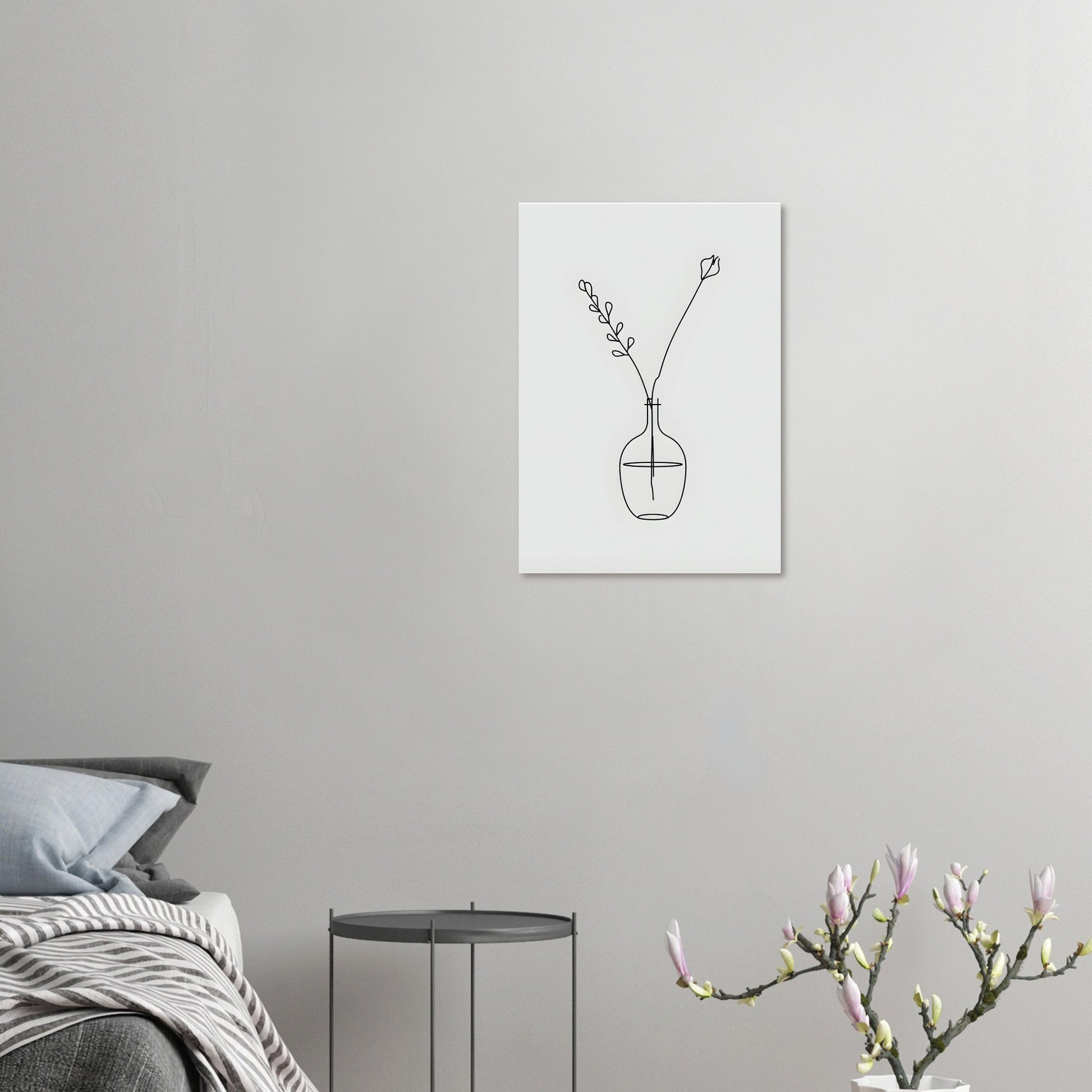 Minimalist line art of a vase with flowers on a gray wall above a bed.