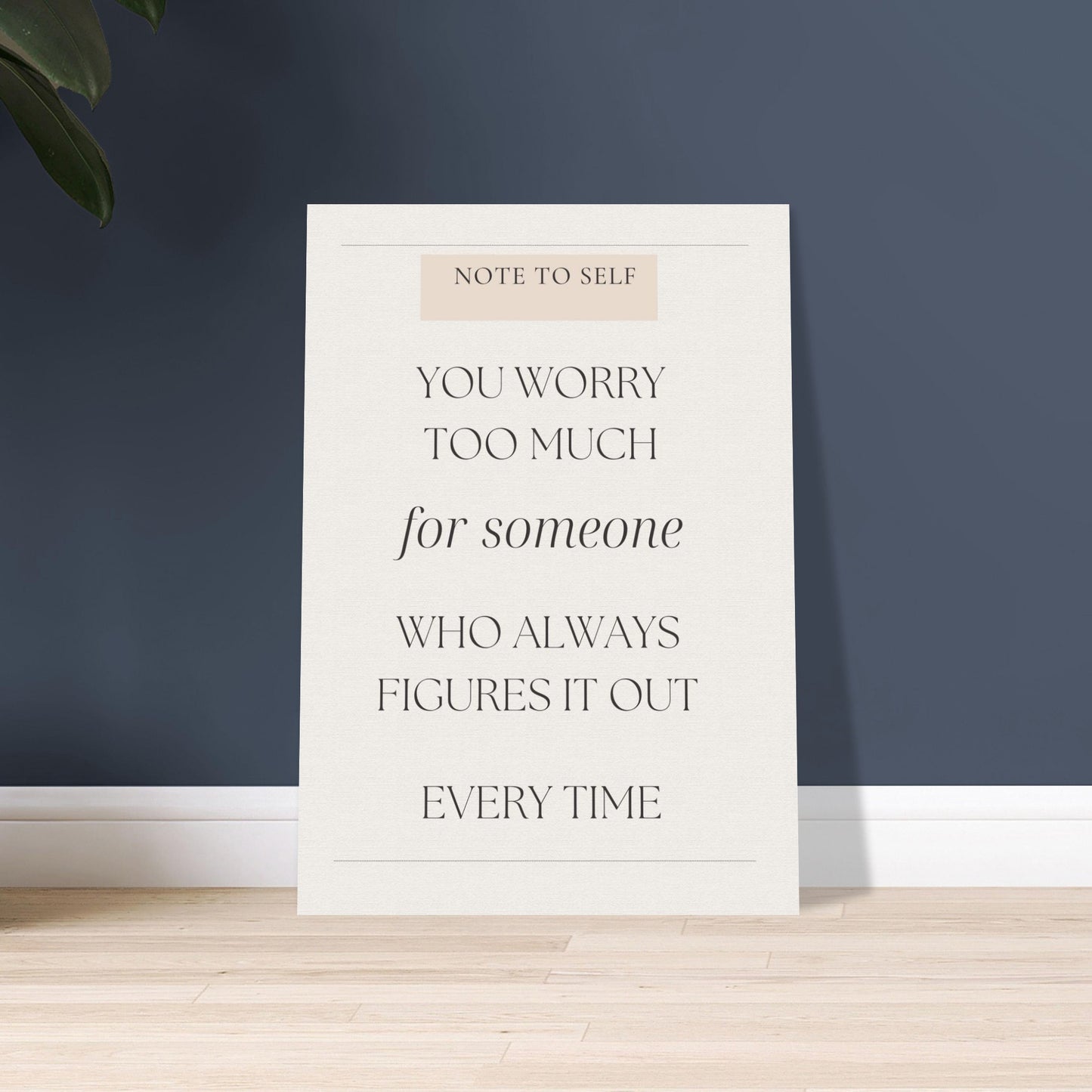 Motivational poster with text on a white background against a dark blue wall.