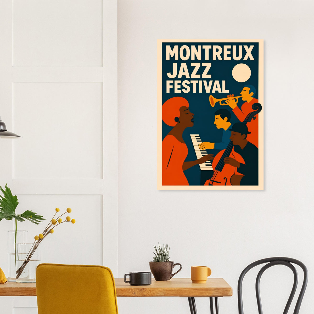 A framed vintage-style poster reading 'Montreux Jazz Festival' hangs on a white wall above a dining table with chairs and small decor items. The poster features bold cream text and illustrated jazz musicians in orange, dark blue, and yellow tones.