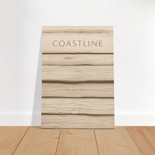 Minimalist Coastline poster with driftwood texture leaning against a white wall on wooden flooring
