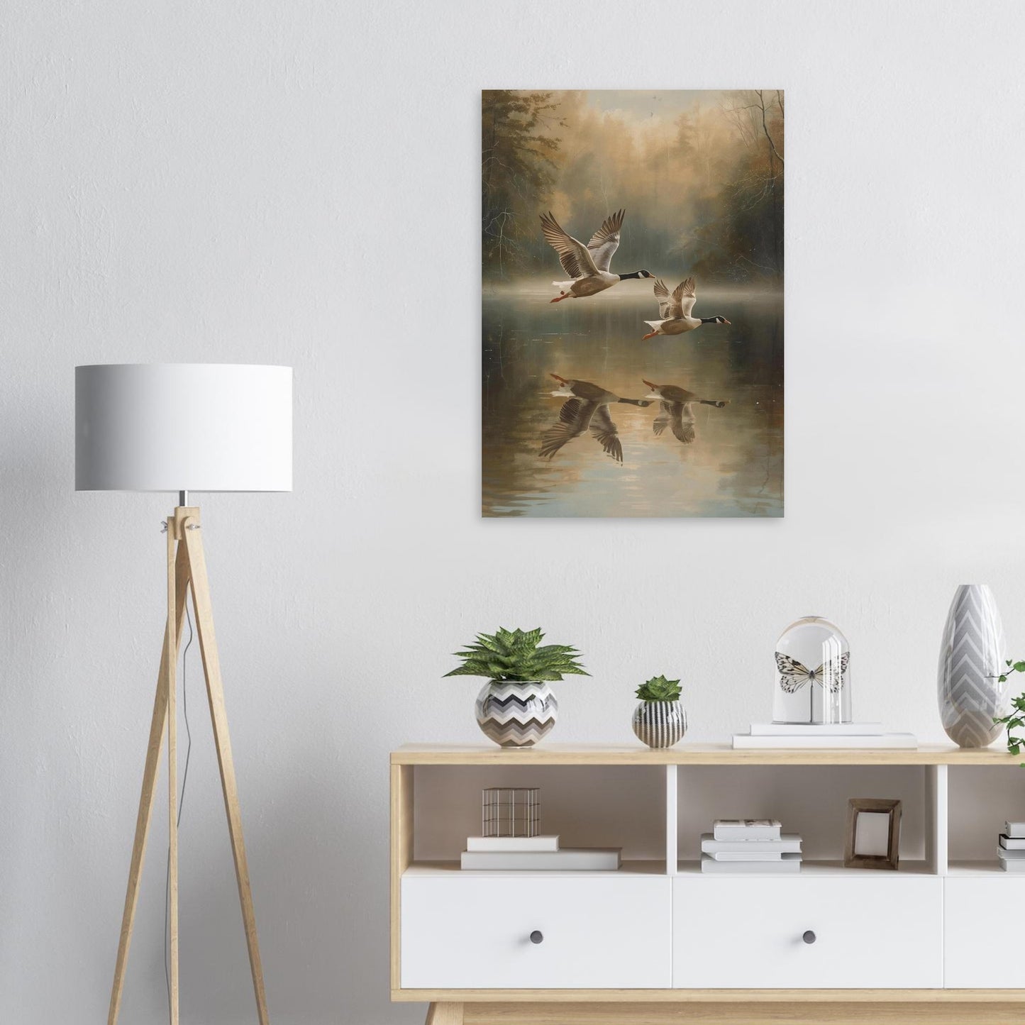 Room interior with a painting of birds over water, a lamp, and a shelf with decor items.