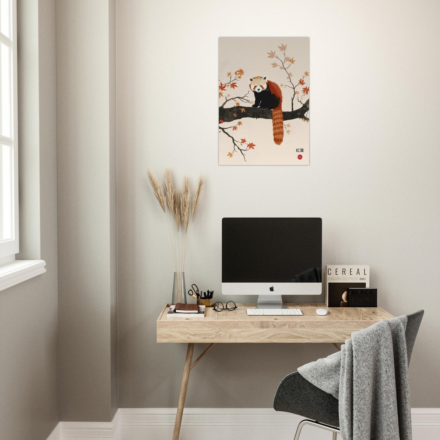 Modern home office with a desk, computer, and wall art of a red panda.
