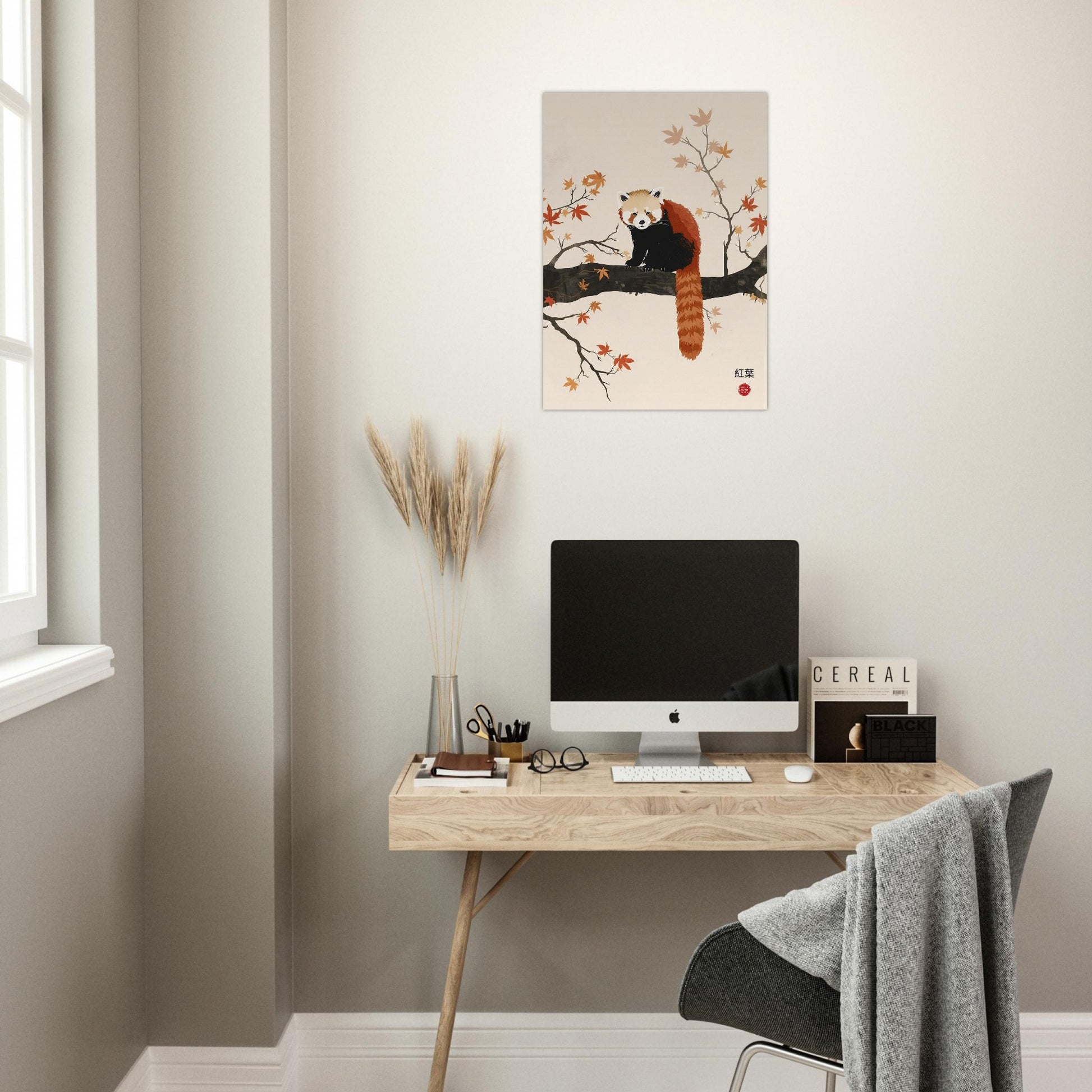 Modern home office with a desk, computer, and wall art of a red panda.